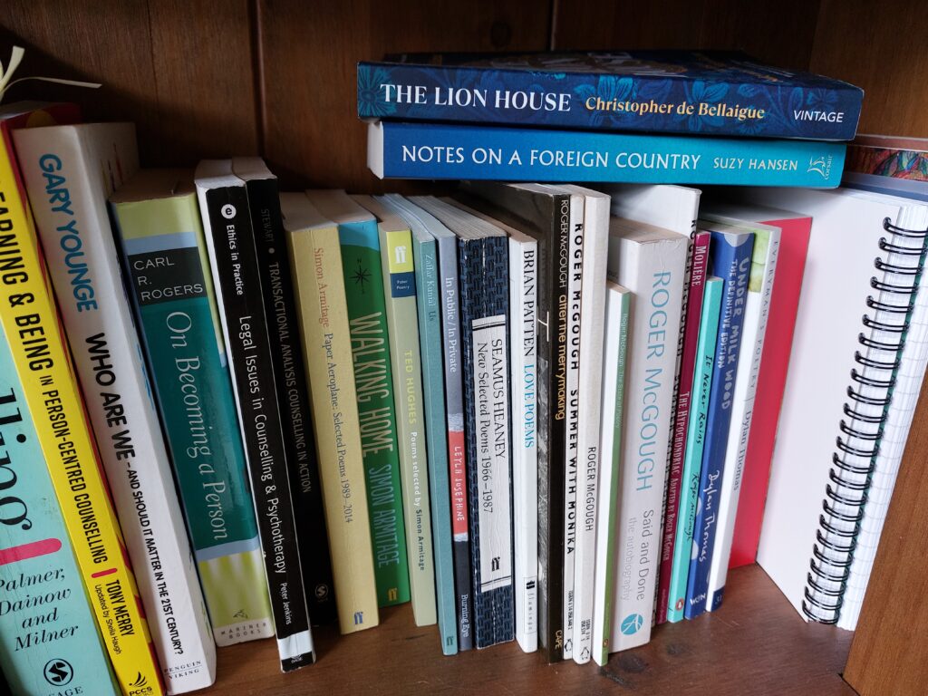 A selection of Jonathan's counselling books on a bookshelf